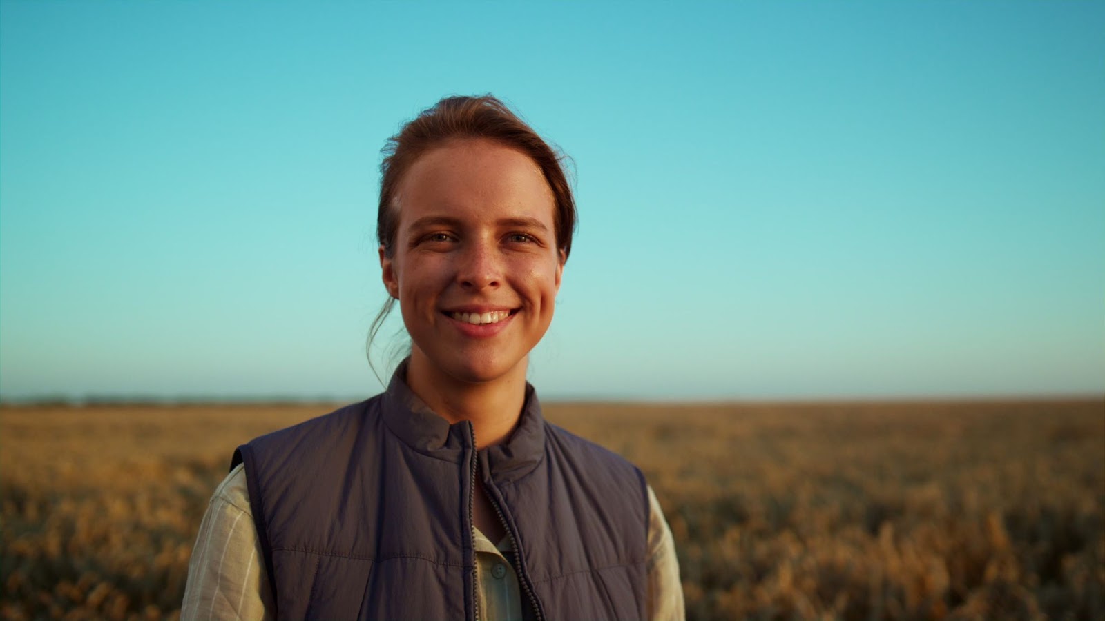 Lady farmer smiling in a farmers field