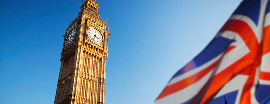 Big Ben and Great Britain flag blue sky