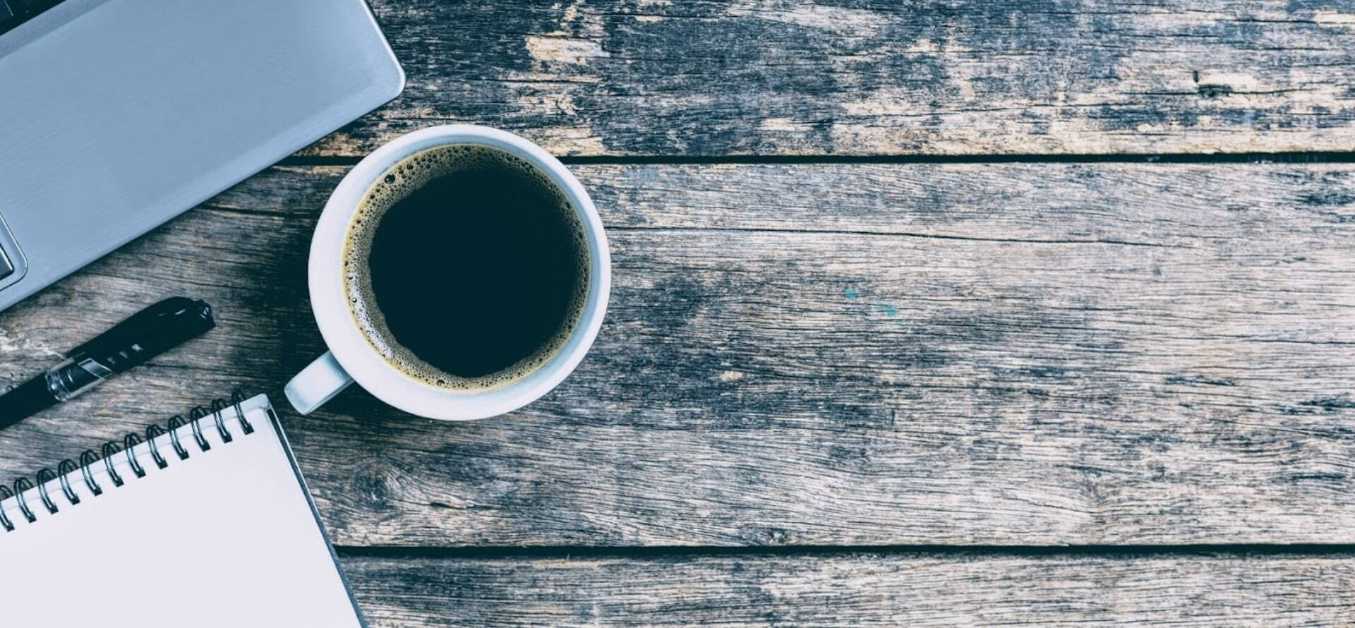 coffee laptop pad on wooden desk