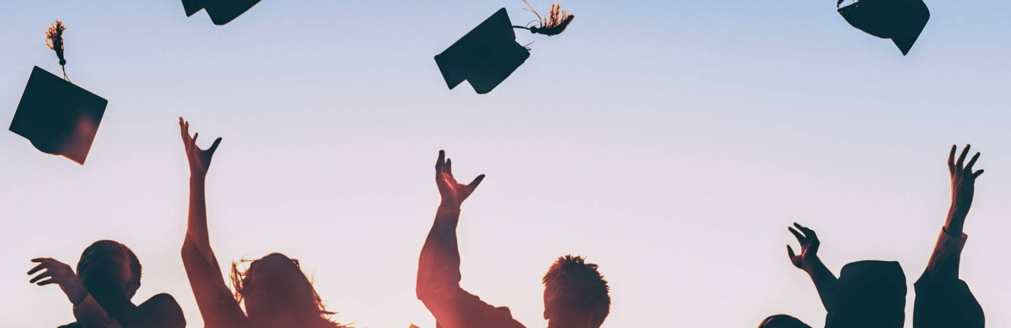 graduates throwing hats in the air