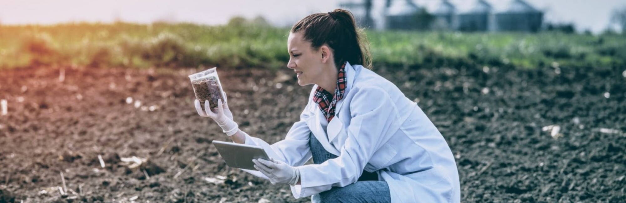 woman agronomist examining soil